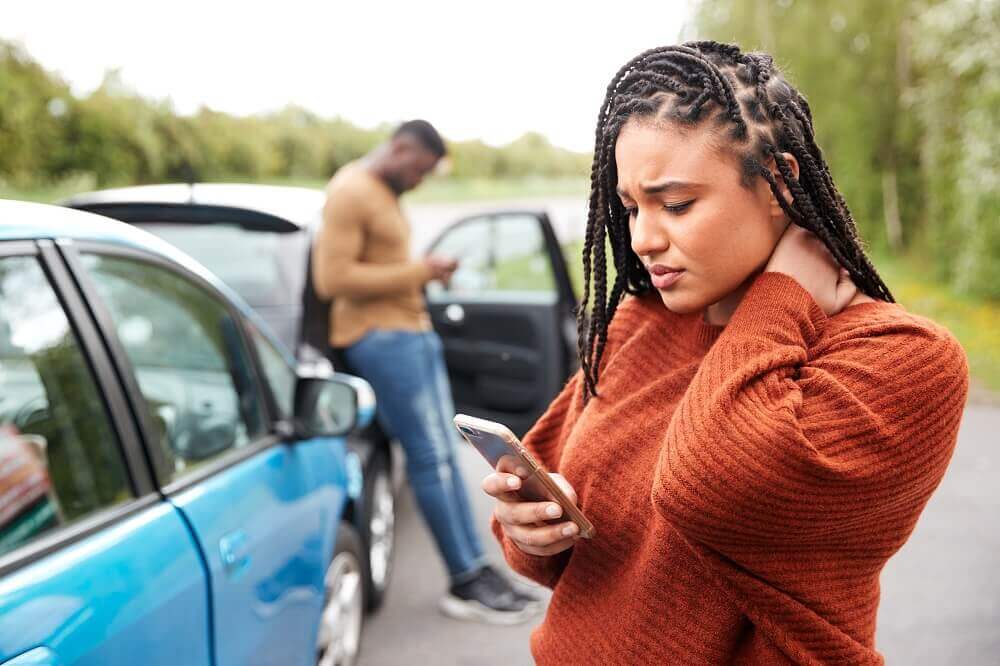 Lady driver suffering pain from whiplash.