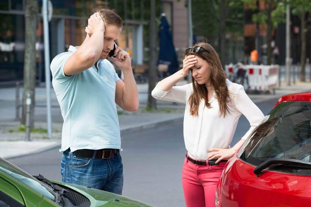 Worried uninsured lady driver causing car accident.