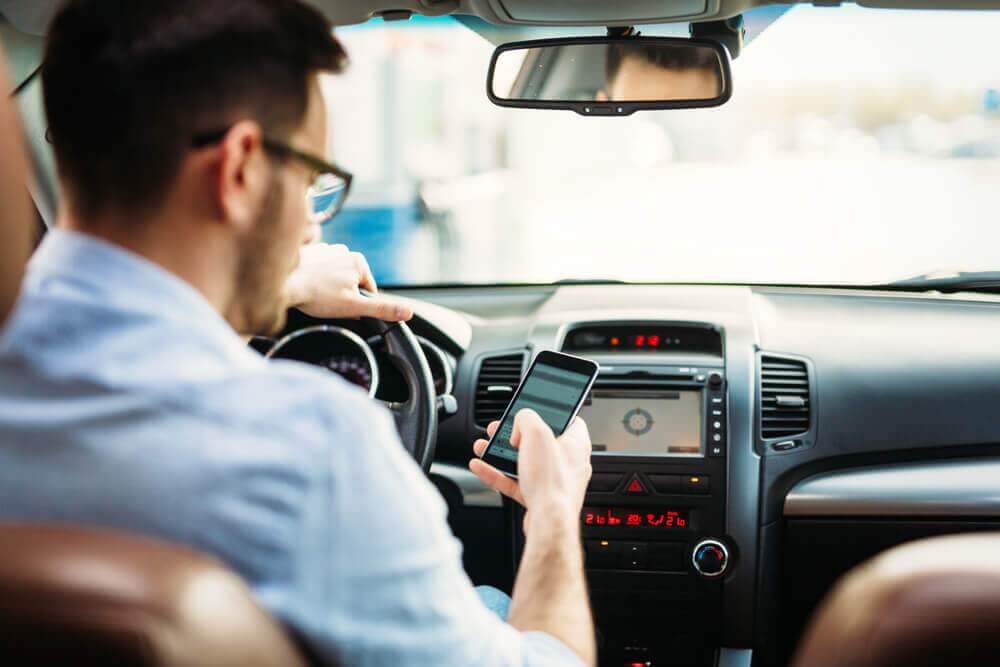 Man driver texting while driving.
