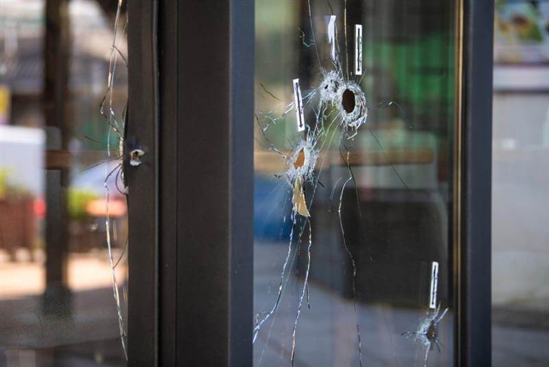 Bullet holes on the window of local restaurant.