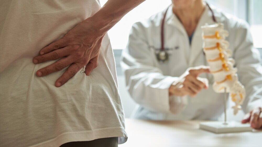 Injured driver suffering back pain like herniated disc from car accident.