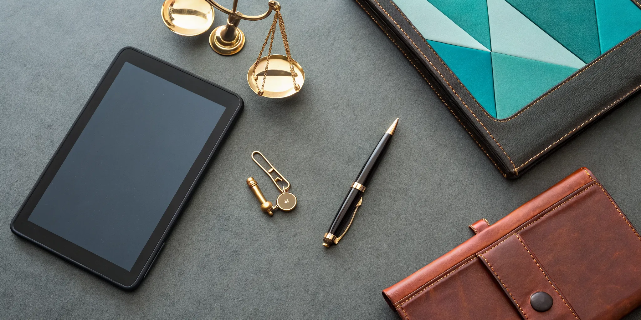 Justice scales and a tablet on a desk showing how much a car accident lawyer costs.
